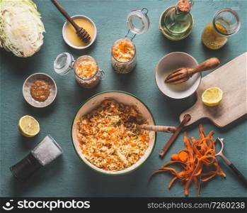 Fresh carrot cabbage salad in jars for healthy lunch with ingredients on kitchen table background, top view, with copy space. Vegetarian food, low-calorie vegetable eating and weight loss dieting