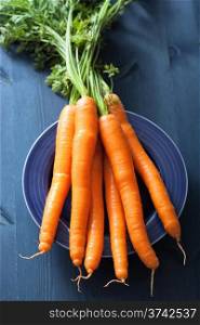 fresh carrot over blue background