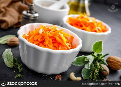 Fresh carrot salad with oil and nuts