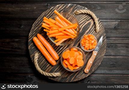 Fresh carrots on a cutting Board with a knife. On wooden background. Fresh carrots on a cutting Board with a knife.