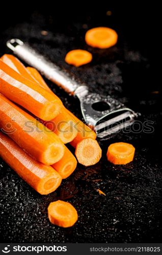 Fresh carrots on the table. On a black background. High quality photo. Fresh carrots on the table.