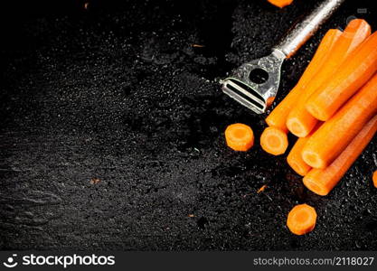 Fresh carrots on the table. On a black background. High quality photo. Fresh carrots on the table.