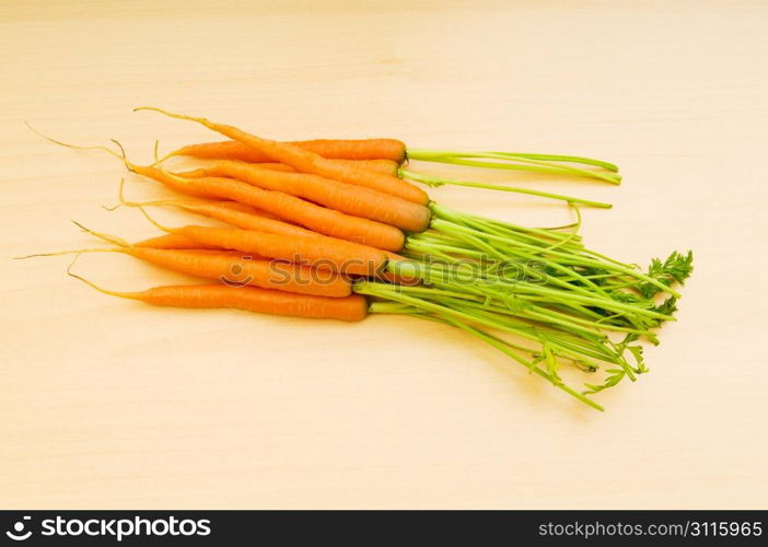 Fresh carrots on the wooden table