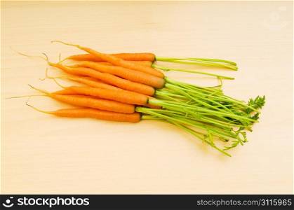 Fresh carrots on the wooden table