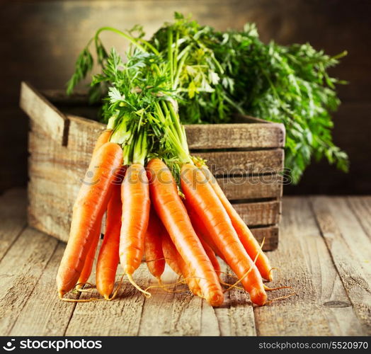 fresh carrots on wooden table