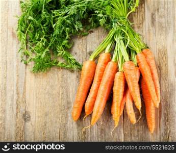 fresh carrots on wooden table