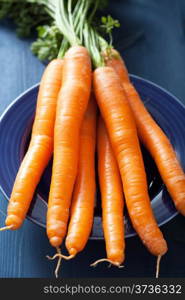 fresh carrots over blue plate