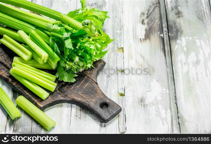 Fresh celery on a cutting Board. On wooden background. Fresh celery on a cutting Board.