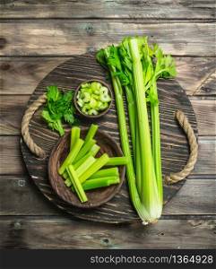 Fresh celery on a tray. On wooden background. Fresh celery on a tray.