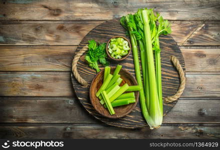 Fresh celery on a tray. On wooden background. Fresh celery on a tray.