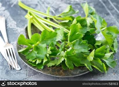 fresh celery on plate and on a table