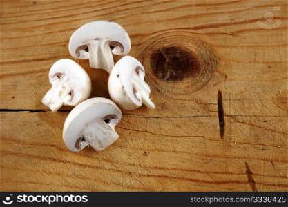 fresh champignon mushroom sliced on wooden background