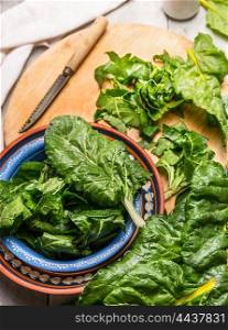 Fresh chard preparation in rustic bowl on wooden background