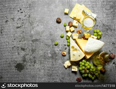 Fresh cheese with grapes and white wine. On the stone table.. Fresh cheese with grapes and white wine.