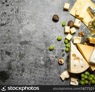 Fresh cheese with grapes and white wine. On the stone table.. Fresh cheese with grapes and white wine.