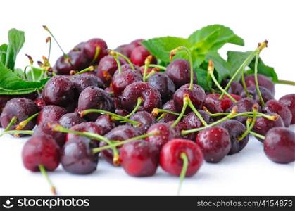 Fresh cherries in water droplets on a white background