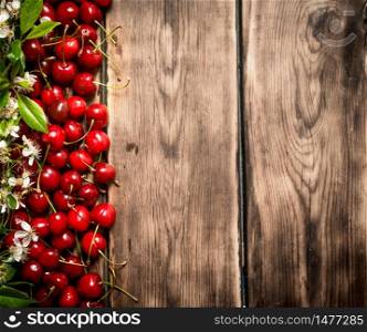 Fresh cherry and brunch blossoms. On wooden background.. Fresh cherry and brunch blossoms.