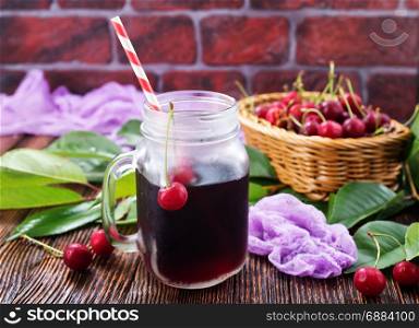 fresh cherry and cherry juice on a table