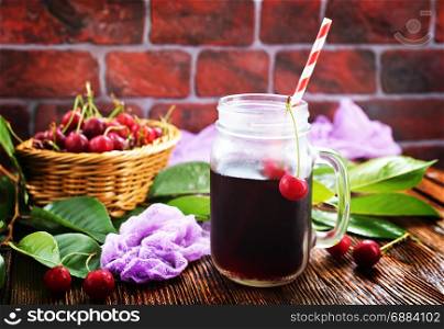 fresh cherry and cherry juice on a table