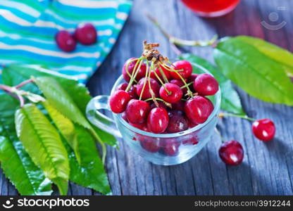 fresh cherry and fresh juice on the wooden table