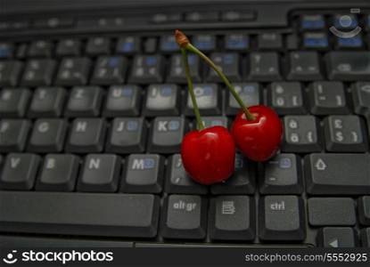 fresh cherry closeup on laptop keyboard