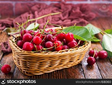 fresh cherry in basket and on a table