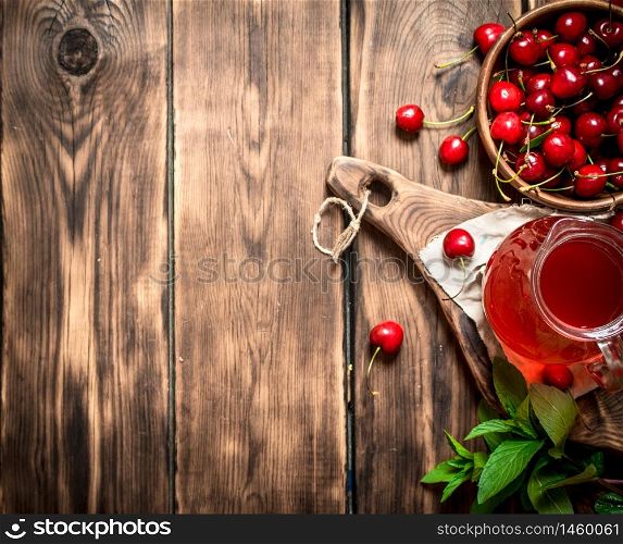 Fresh cherry juice . On a wooden background.. Fresh cherry juice .On wooden background.