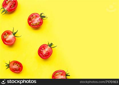 Fresh cherry tomatoes, half cut isolated on yellow background. Copy space
