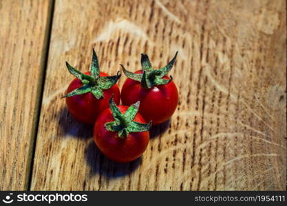 Fresh cherry tomatoes on rustic wooden background