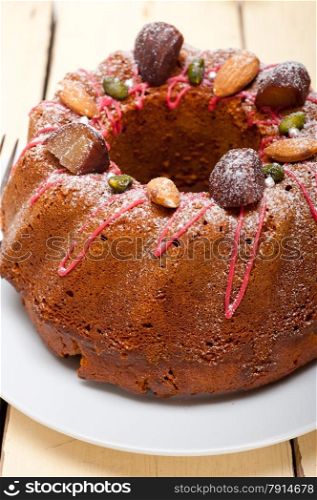fresh chestnut cake bread dessert with almonds and pistachios on top