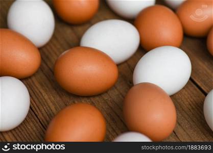 Fresh Chicken eggs and duck eggs on wooden background, white and brown egg nature from farm