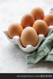 Fresh chicken eggs in  egg tray on concrete background