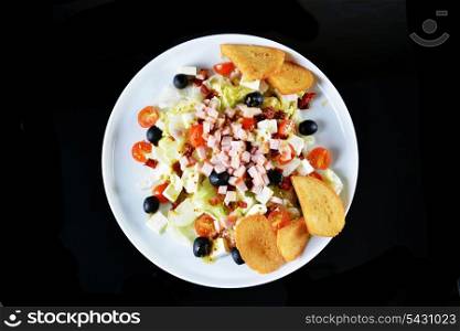 fresh chopped ham salad with cheese on black background