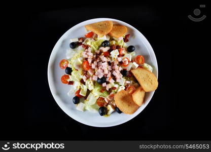 fresh chopped ham salad with cheese on black background
