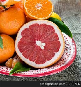 Fresh citrus fruits on rustic background, closeup