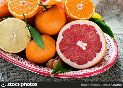 Fresh citrus fruits on rustic background, closeup