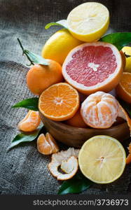 Fresh citrus fruits on rustic background, selective focus