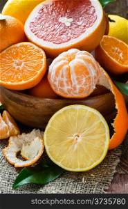 Fresh citrus fruits on rustic background, selective focus, closeup
