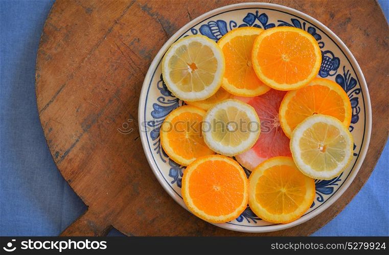 Fresh citrus fruits on vintage plate