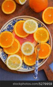 Fresh citrus fruits on vintage plate