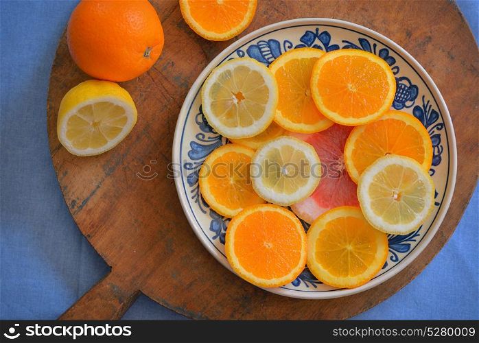 Fresh citrus fruits on vintage plate. Fresh citrus fruits