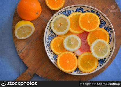 Fresh citrus fruits on vintage plate. Fresh citrus fruits