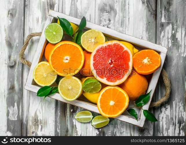 Fresh citrus in tray. On wooden background. Fresh citrus in tray.