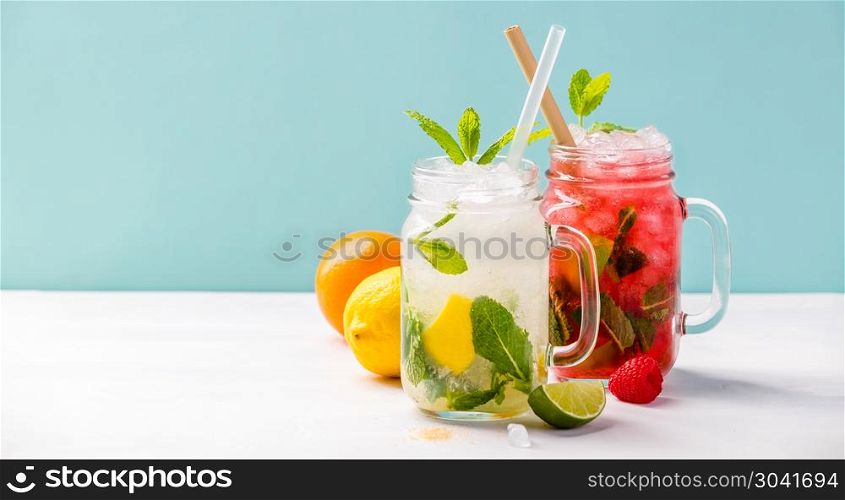 Fresh cocktail drinks with ice fruit and herb decoration. Alcoholic non-alcoholic drink-beverage. Mojito on blue background. Fresh cocktail drinks. Fresh cocktail drinks