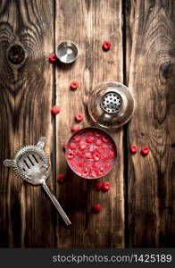 fresh cocktail of wild raspberries in a shaker. On a wooden table.. fresh cocktail of wild raspberries in a shaker.