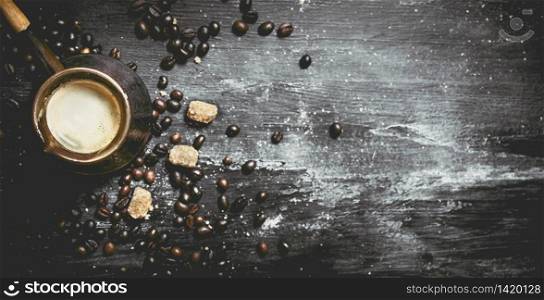 Fresh coffee pot with cane sugar and roasted grains. On a black chalkboard.. Fresh coffee pot with cane sugar and roasted grains.
