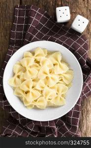 Fresh cooked farfalle, bow-tie or butterfly pasta served in bowl without sauce, photographed overhead. Cooked Farfalle Pasta