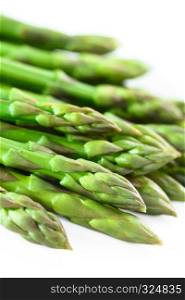 Fresh cooked green asparagus on white plate (Selective Focus, Focus on the asparagus head one third into the image). Cooked Green Asparagus