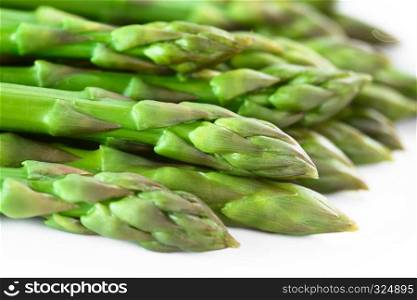 Fresh cooked green asparagus on white plate (Selective Focus, Focus on the asparagus head in the middle of the image). Cooked Green Asparagus
