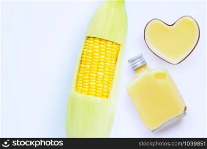 Fresh corn with sweet corn juice or corn milk on white background. Copy space